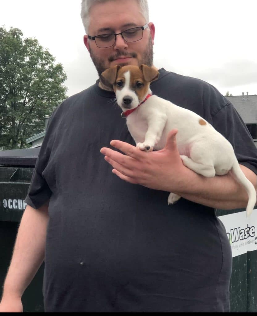Tom before training at Capital Fitness, holding a small dog